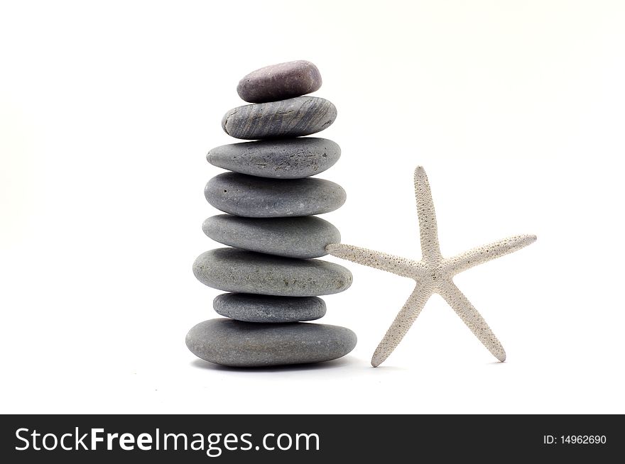 Stack stones with starfish on white