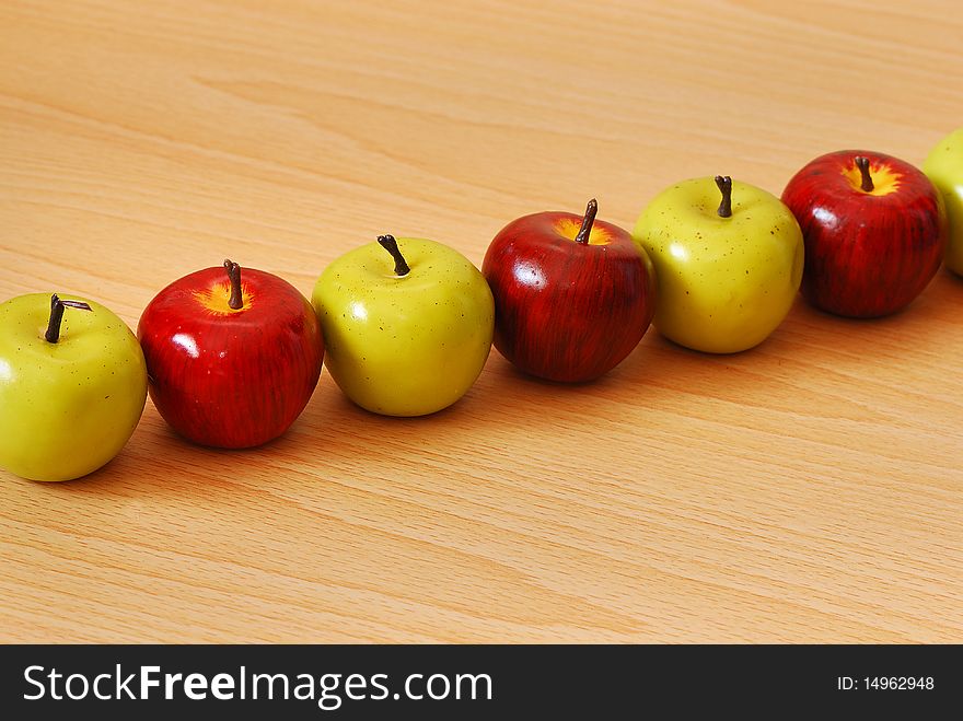 A single row of red and green apples. A single row of red and green apples