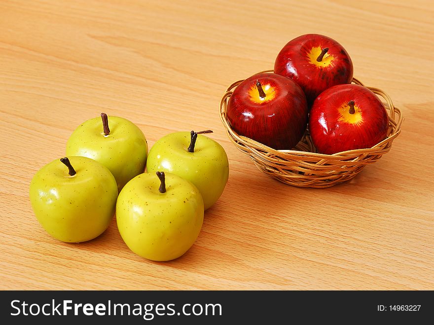 Four  loose green apples  and three red apples in a basket. Four  loose green apples  and three red apples in a basket