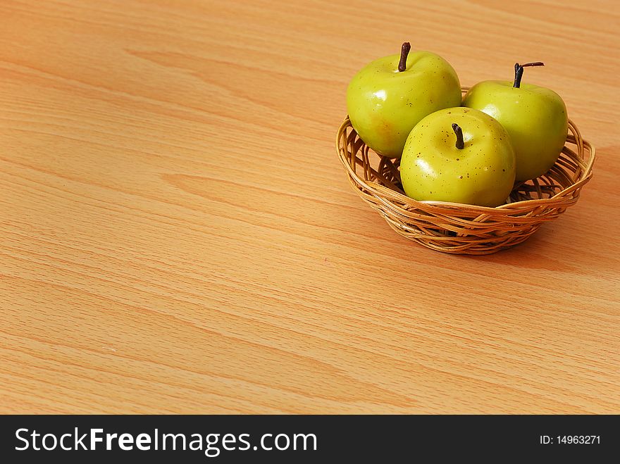 A basket with three green apples. A basket with three green apples