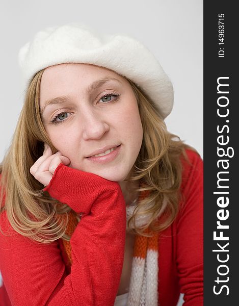 Smiling beautiful young woman in white beret