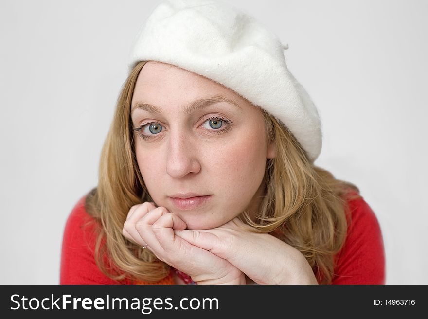 Smiling beautiful young woman in white beret