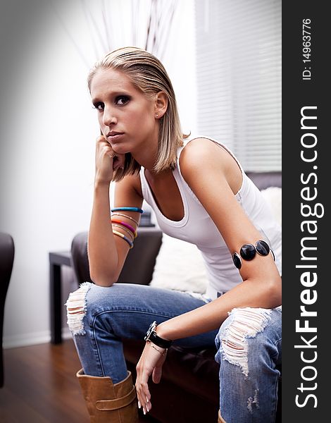 Beautiful young contemporary teenager with an attitude wearing  tank top and jeans. Beautiful young contemporary teenager with an attitude wearing  tank top and jeans