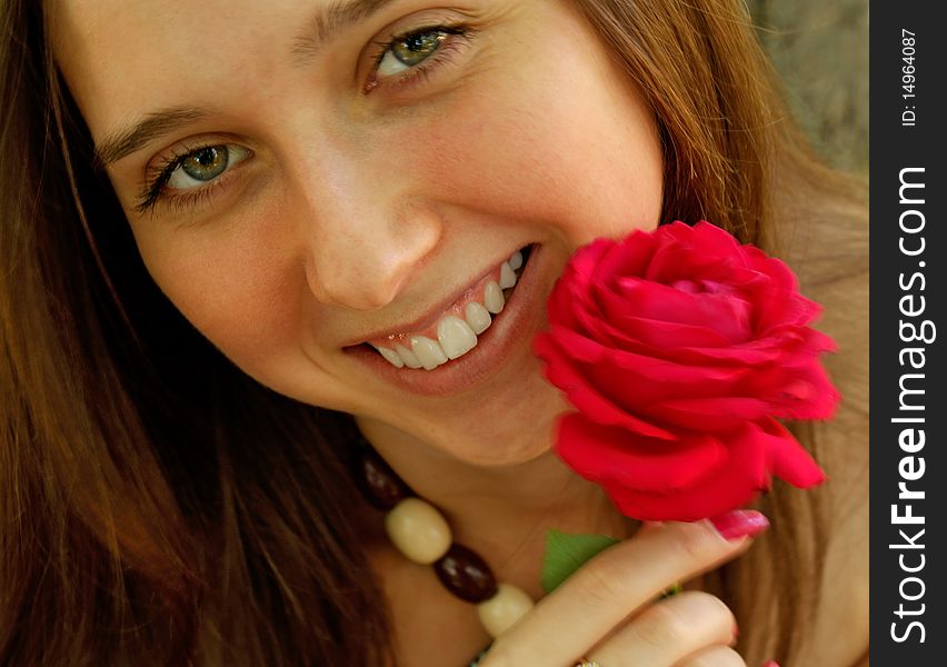 Charming young woman enjoy aroma beautiful red rose. Charming young woman enjoy aroma beautiful red rose