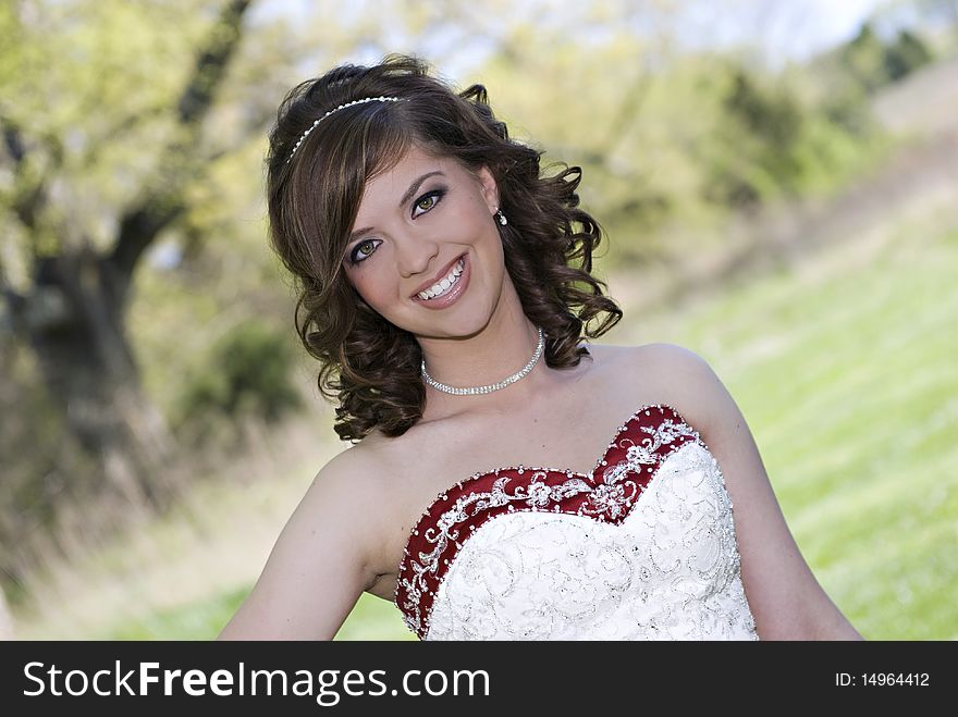 A beautiful smiling bride with selective focus and scenic background