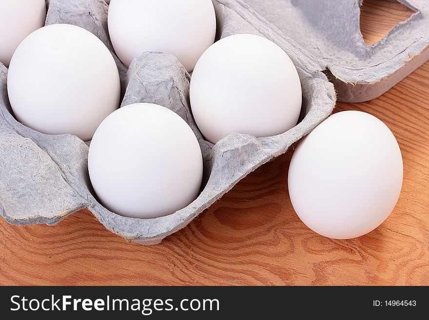 Eggs of white colour are combined in a special tray for transportation and sale.