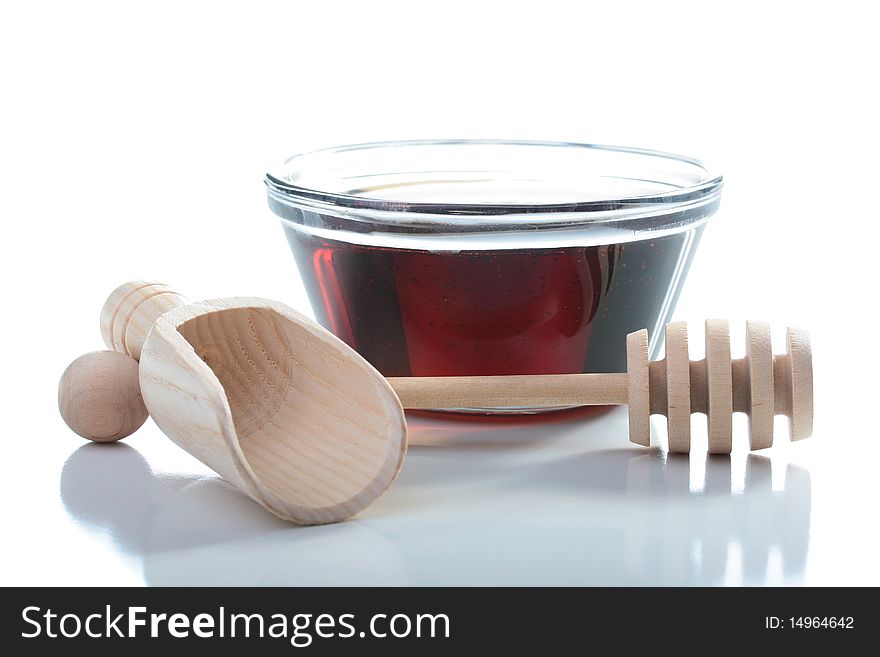 Honey in glasswares with wooden honey dipper.