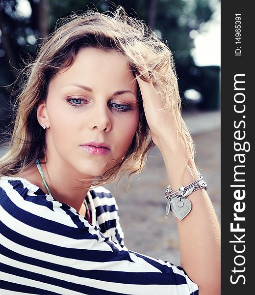 Young pretty fashion woman outdoors in sunny summer day thinking. Young pretty fashion woman outdoors in sunny summer day thinking