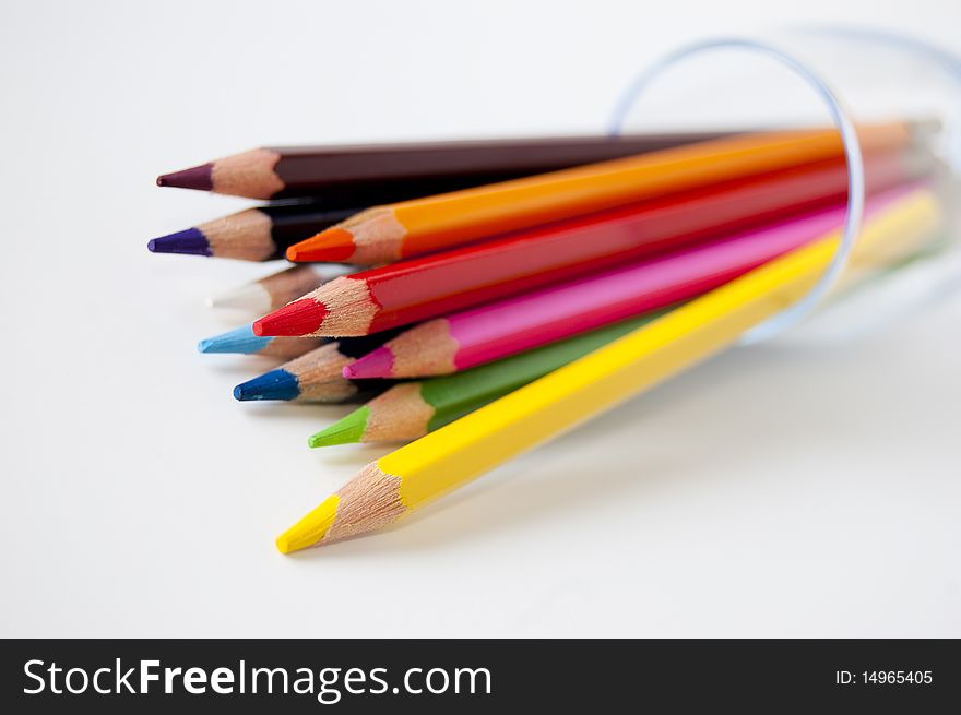 Close up of many colored pencils in a glass