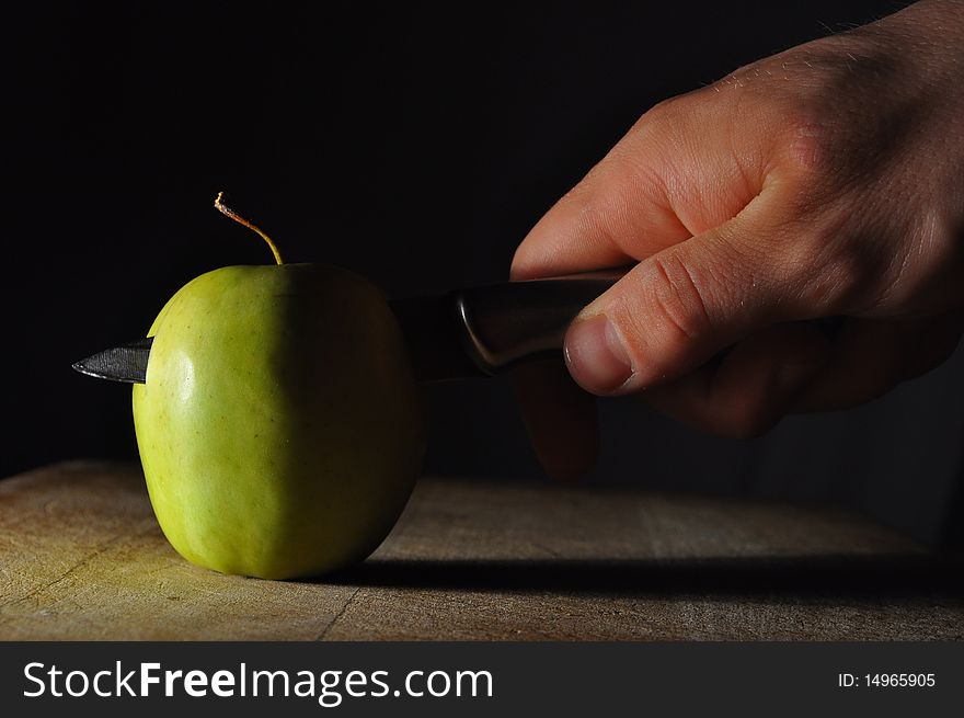 Man's Hands cutting an Apple