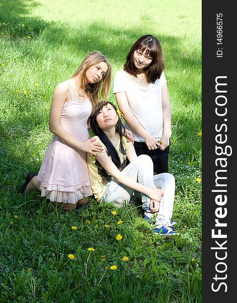 Three girls sitting on grass