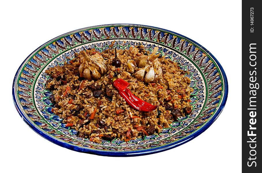 Central Asian plov on a dish with national painting