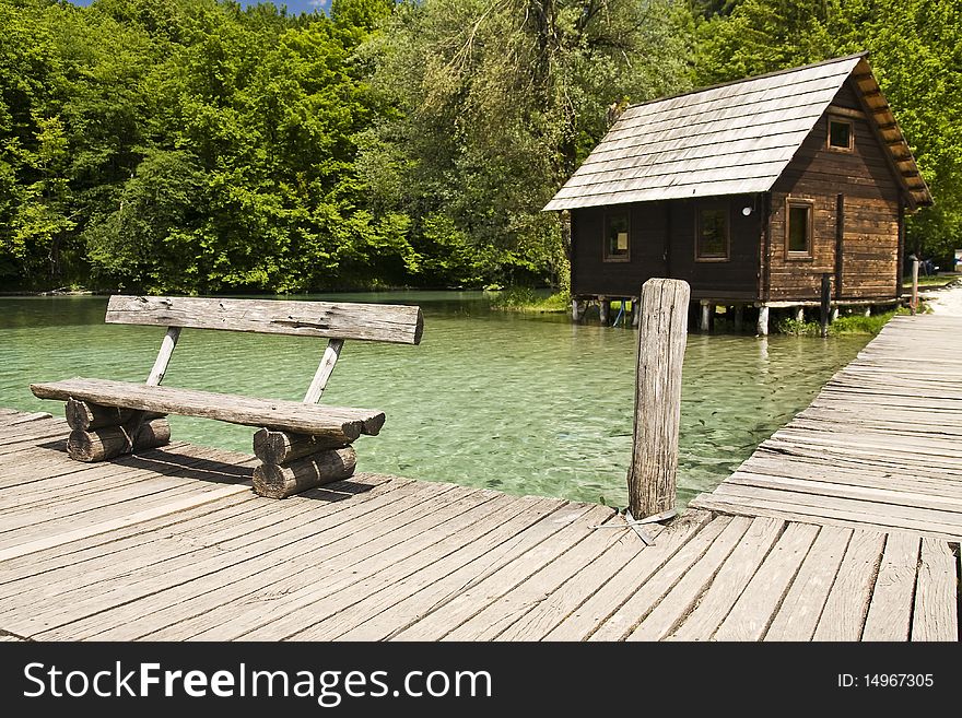 Bench and cabin on the shore of a lake