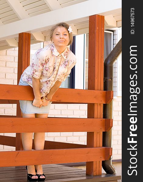 Funny girl standing on a veranda