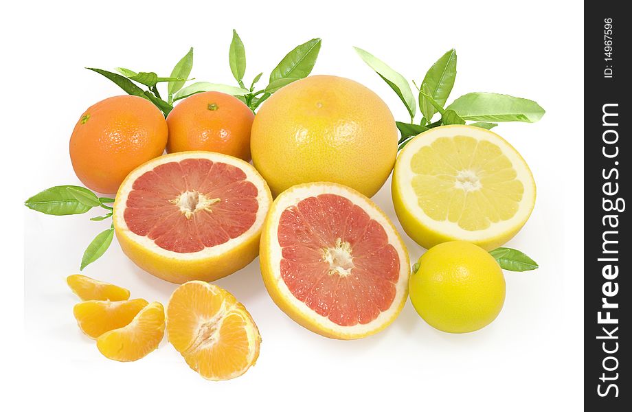 Group of different fresh citrus fruits with green leaves isolated on white with clipping path