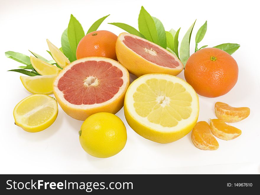 Group of fresh different citrus fruits with green leaves isolated on white with clipping path