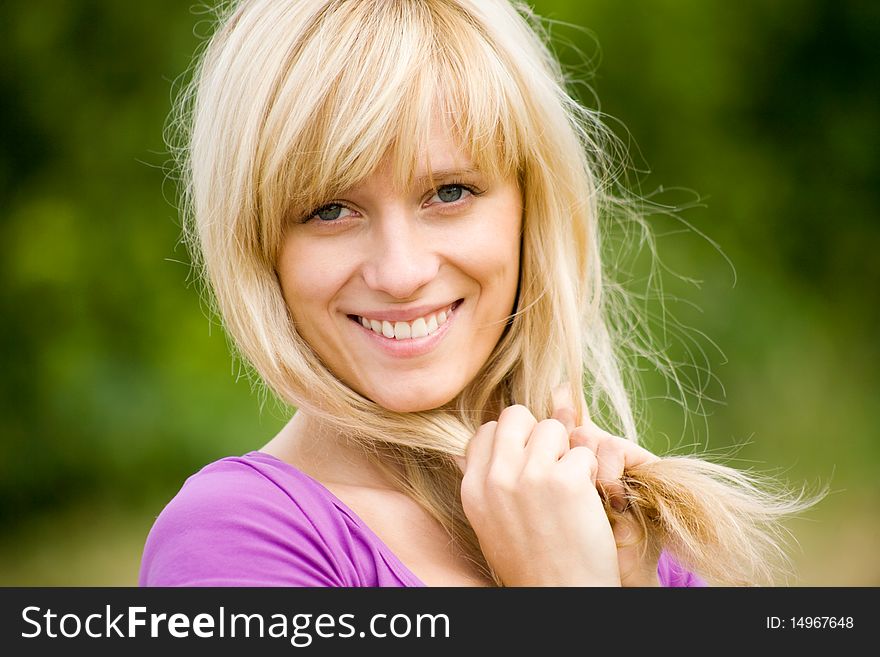 Portrait of young beautiful woman with fair hair on  background  of green forest. Portrait of young beautiful woman with fair hair on  background  of green forest