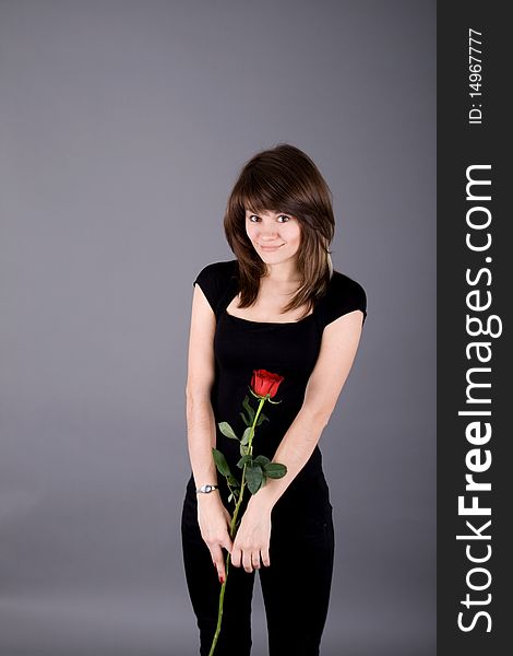 Beautiful girl with rose studio shot