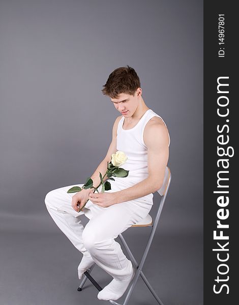 Handsome man with rose in studio