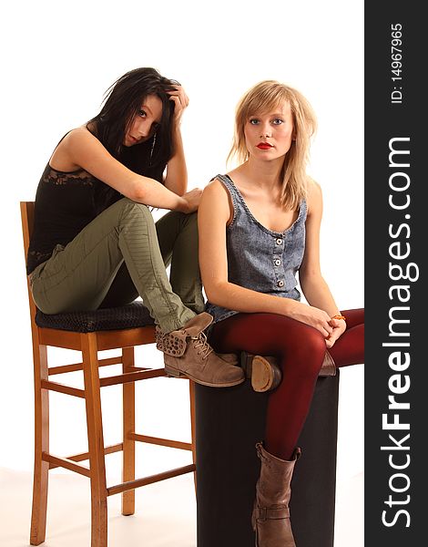 Two attractive teenage girls posing together for portraits. Two attractive teenage girls posing together for portraits