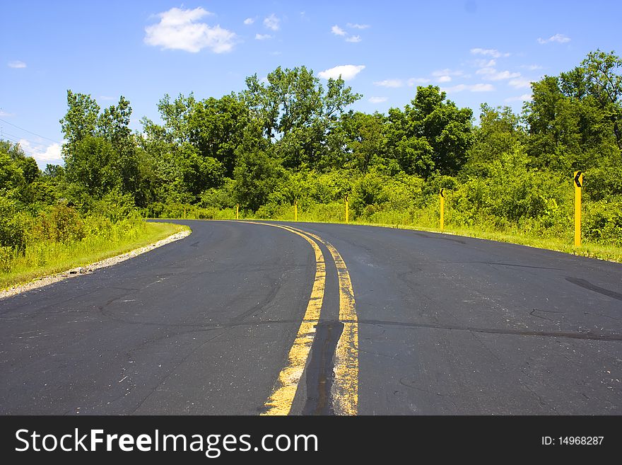 A turn in a black asphalt Road. A turn in a black asphalt Road