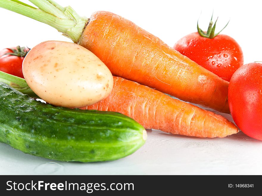 Close-up shot of fresh wet vegetables, isolated on white background