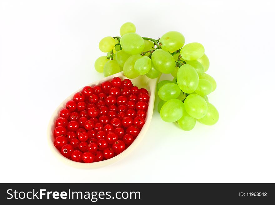 Grape and red currant isolated on white