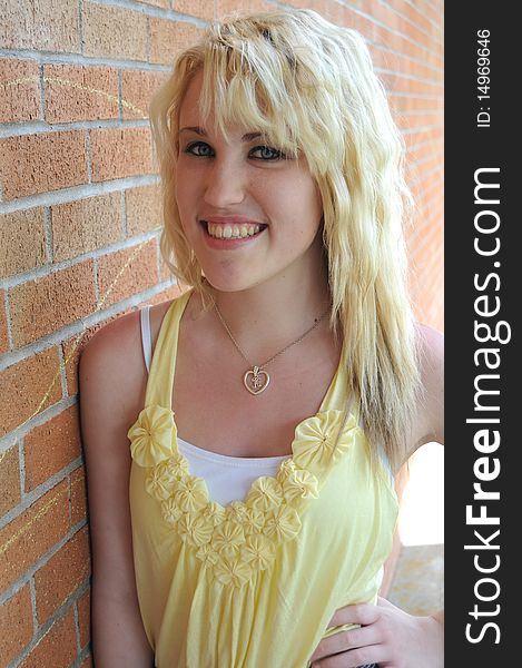 Girl standing next to brick wall