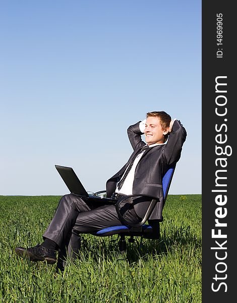 Businessman in the field, with a laptop. Happy, successful. Businessman in the field, with a laptop. Happy, successful