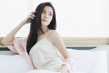 Asian Woman Model Sitting And Posing On Bed Stock Images