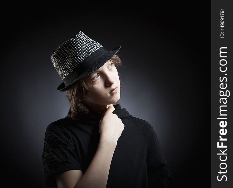 Portrait of a Boy with Blond Hair in Hat and Black Top