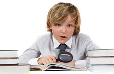 Schoolboy With Books And Magnifying Glass Stock Photo