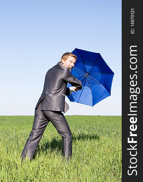 Business Man With An Open Umbrella.Protection