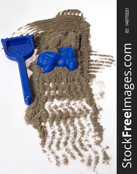 Sand play set - rack, mold and a pile of sand, on a white background. Sand play set - rack, mold and a pile of sand, on a white background