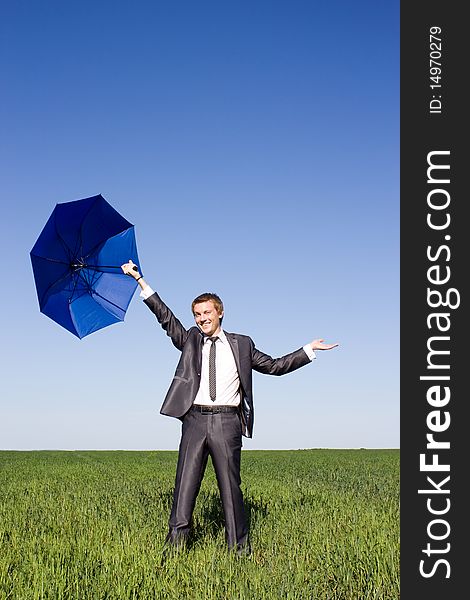 Businessman finding protection outside in the field. Businessman finding protection outside in the field