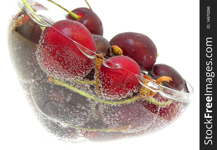 Ripe cherry in the soda isolated white background