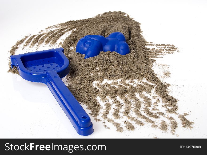 Sand play set - rack, mold and a pile of sand, on a white background. Sand play set - rack, mold and a pile of sand, on a white background