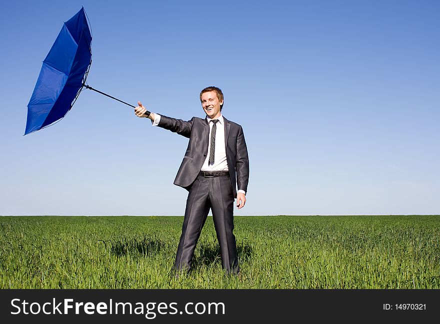 Businessman in a suit claiming the wind. Businessman in a suit claiming the wind