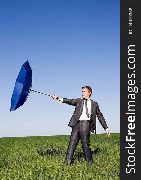 Conceptual photo of businessman flying on his umbrella up into bright blue sky. Conceptual photo of businessman flying on his umbrella up into bright blue sky