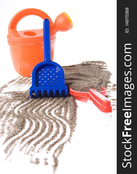 Sand play set - bucket, shovel, rack and a pile of sand, on a white background. Sand play set - bucket, shovel, rack and a pile of sand, on a white background