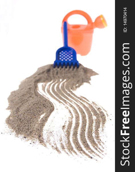 Sand play set - bucket, rack and a pile of sand, on a white background. Sand play set - bucket, rack and a pile of sand, on a white background