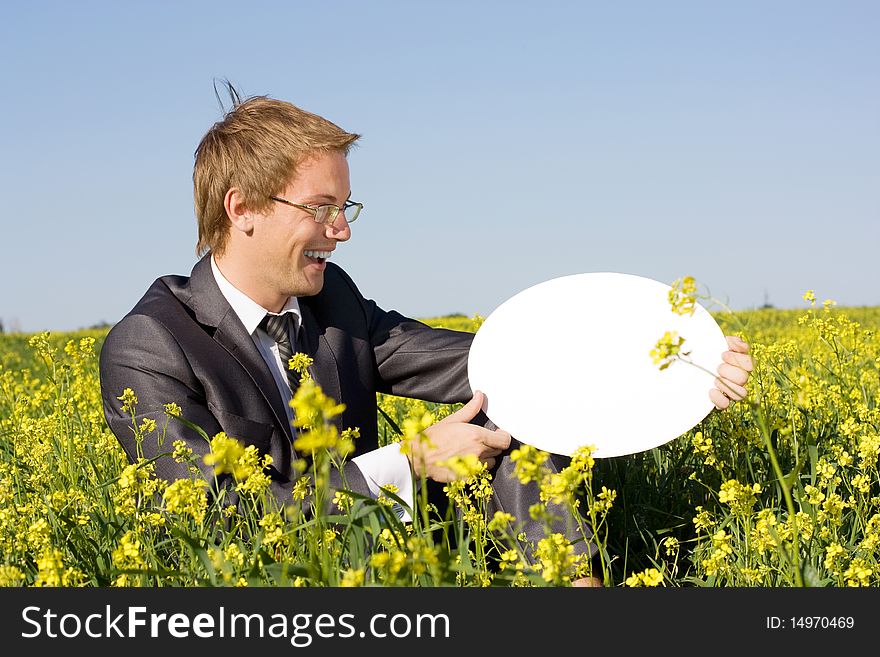 Young businessman in a yellow box holds form