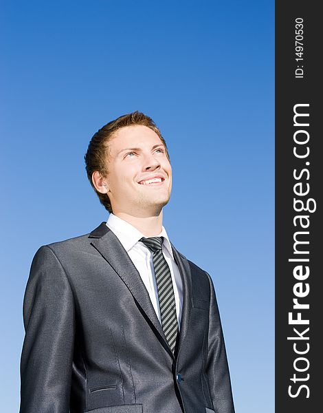 Successful businessman in a suit against the blue sky. Successful businessman in a suit against the blue sky