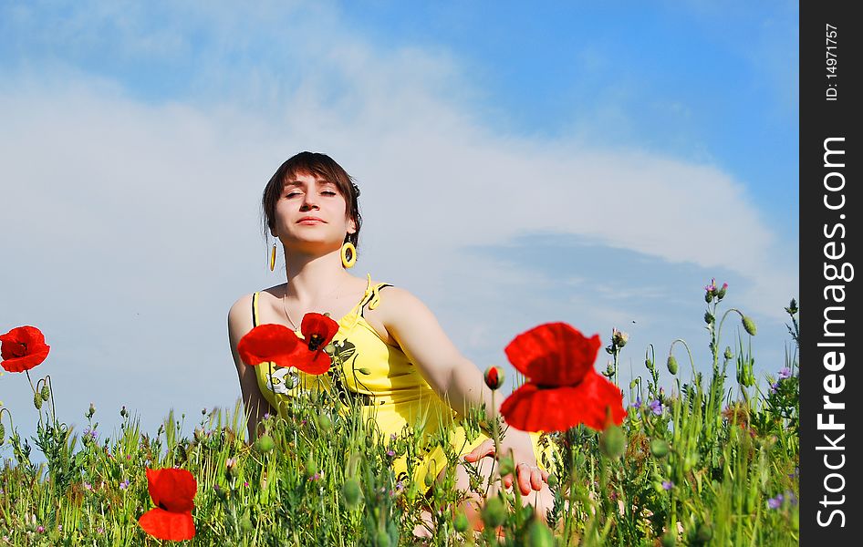 Beautiful girl sitting in the grass