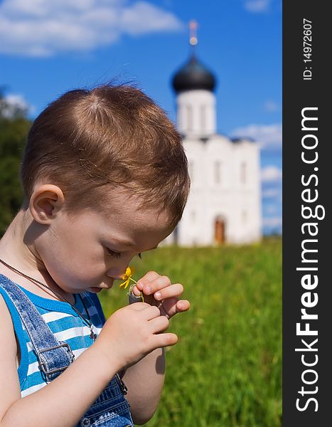 Little boy on a orthodox church background. Church of the Intercession on the Nerl (Vladimir region of Russia). Little boy on a orthodox church background. Church of the Intercession on the Nerl (Vladimir region of Russia)