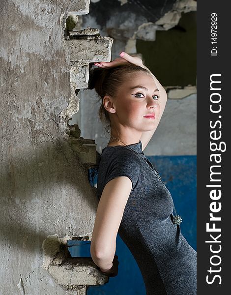 Attractive young lady posing somewhere in industrial ruins. Attractive young lady posing somewhere in industrial ruins