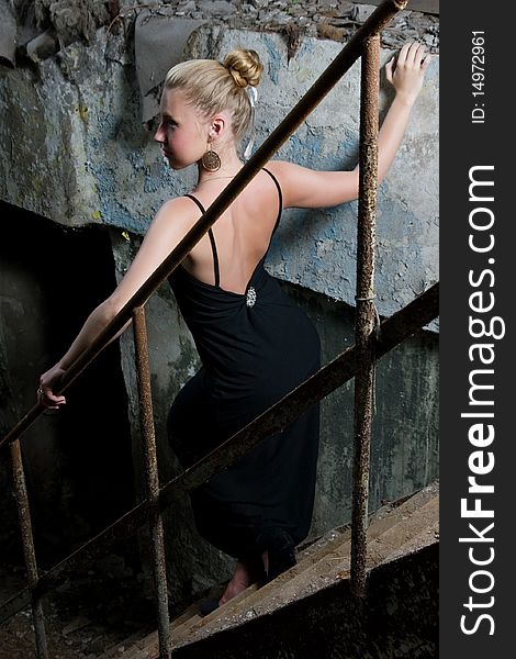 Beautiful Woman Standing On The Grungy Stairs