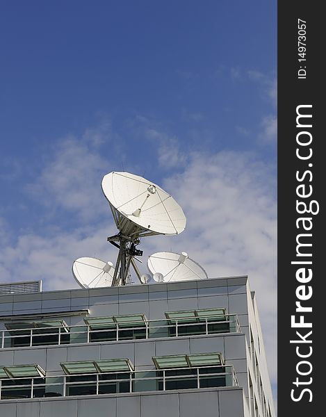 Satellite Dishes on a roof with blue sky background