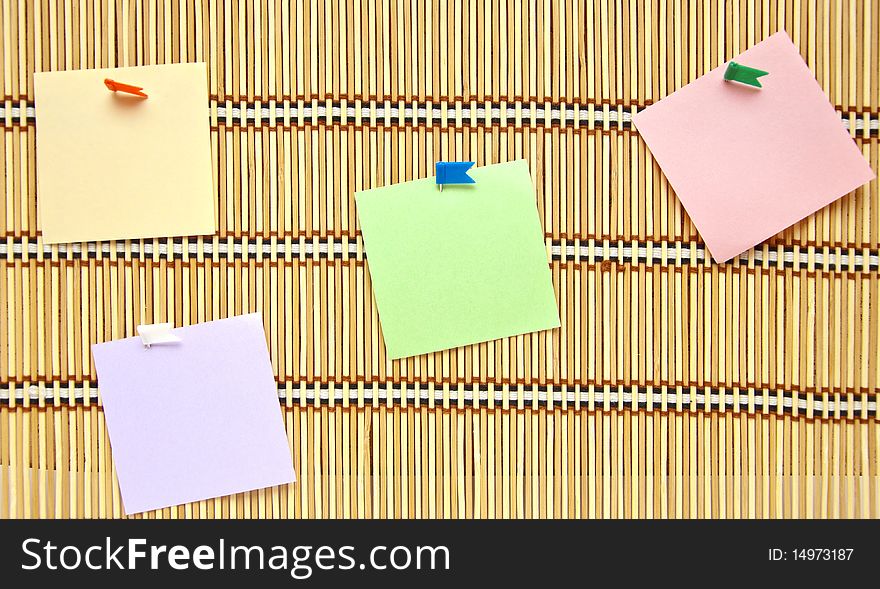 Pure colourful papers with tags on straw background