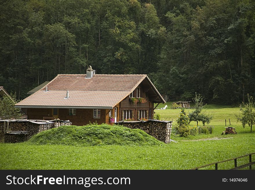 A well-kept farmhouse with colorful windowboxes in the Swiss Alps. A well-kept farmhouse with colorful windowboxes in the Swiss Alps.